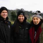 A group of people smiling against a bush ridgeline