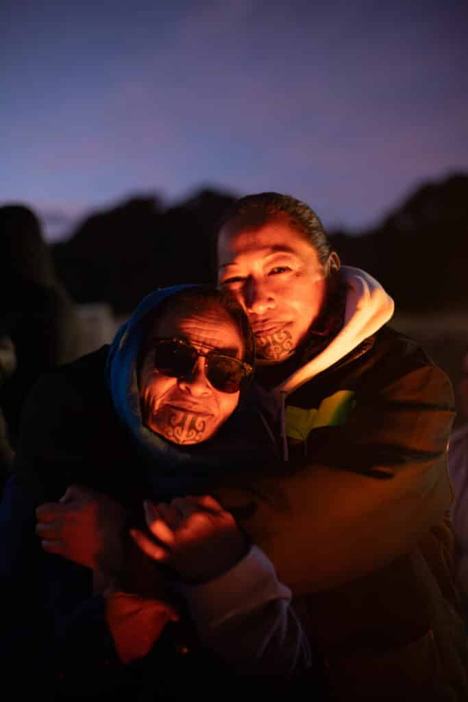 Two woman hold each other in an embrace